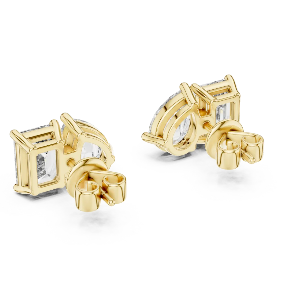 Two stone lab grown diamond stud earrings featuring pear and emerald cut stones set in lustrous yellow gold.