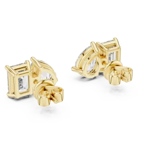 Two stone lab grown diamond stud earrings featuring pear and emerald cut stones set in lustrous yellow gold.