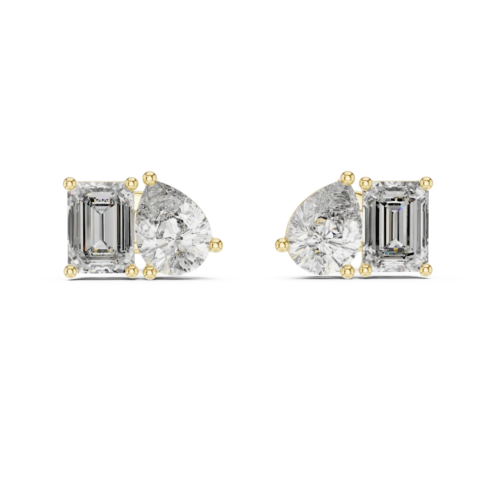 Two stone stud earrings featuring a lab grown pear shaped and emerald cut diamond set in lustrous gold.