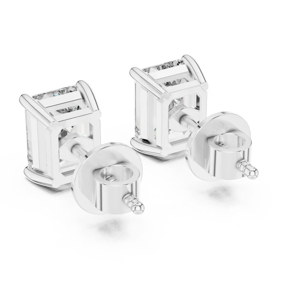 Architectural Emerald Cut Solitaire Stud Earrings featuring geometric silver settings and DIAMEUR diamonds on white surfaces.
