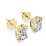 Architectural emerald cut solitaire stud earrings featuring DIAMEUR diamonds set in polished yellow gold.