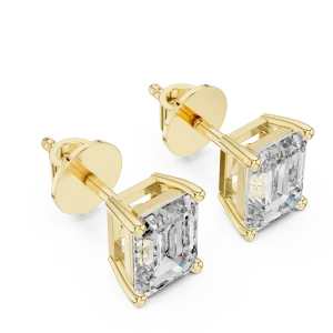 Architectural emerald cut solitaire stud earrings featuring DIAMEUR diamonds set in polished yellow gold.