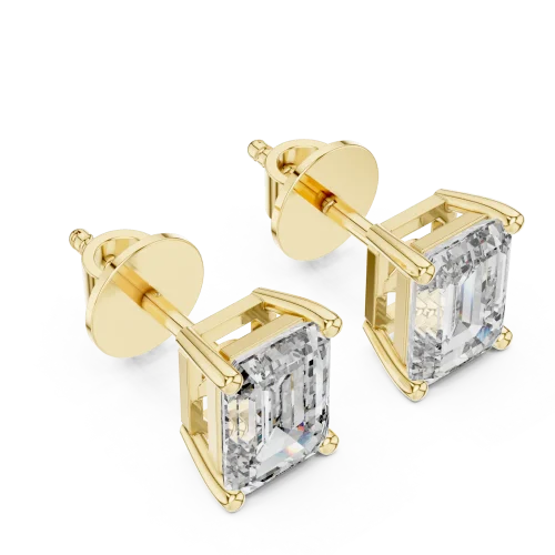 Architectural emerald cut solitaire stud earrings featuring DIAMEUR diamonds set in polished yellow gold.