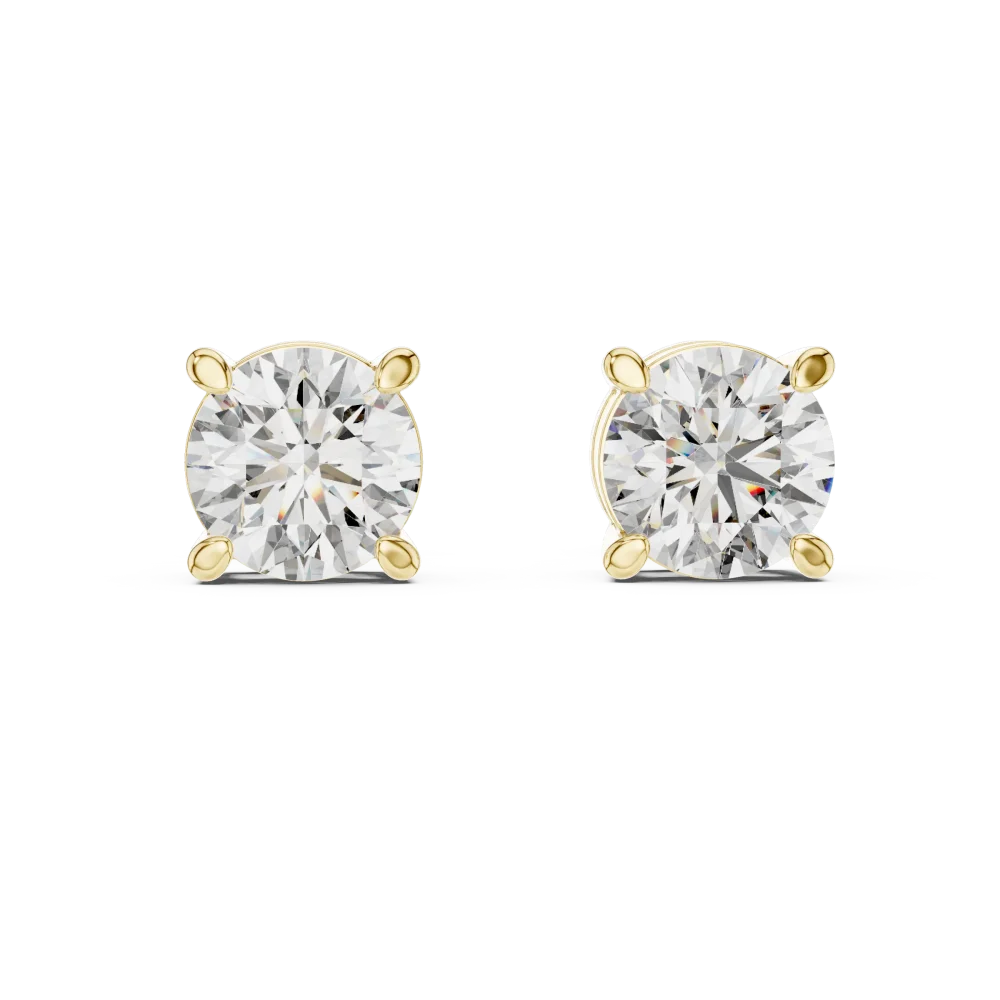 Classic round solitaire diamond stud earrings set in four-prong gold mounts for maximum sparkle and light reflection.