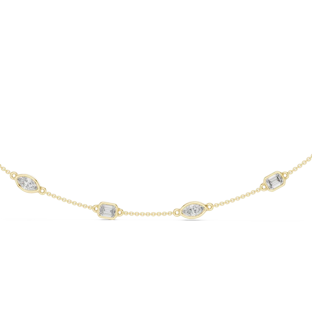 Discover the radiant allure of this bezel station necklace, featuring emerald and marquise DIAMEUR diamonds. Experience modern luxury. Shop now!