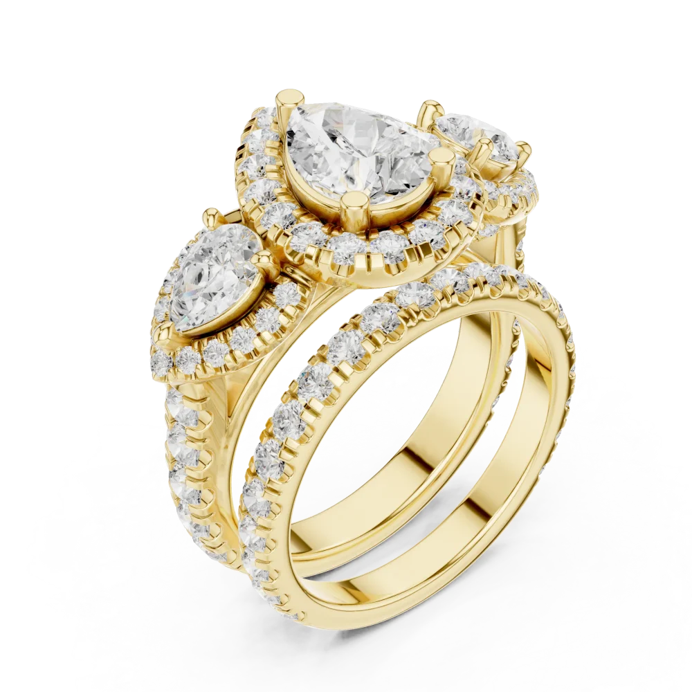 Celebrate love with our Pear Solitaire Three-Stone Ring, featuring brilliant DIAMEUR diamonds set in fine gold. Elevate your collection with this icon.
