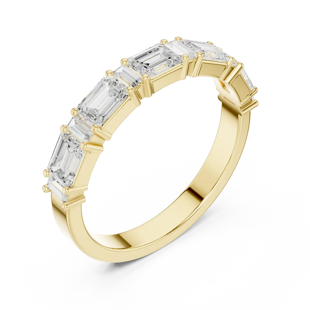 Adorn your finger with this elegant linear band featuring emerald and baguette DIAMEUR diamonds. Experience timeless luxury and shop this creation.