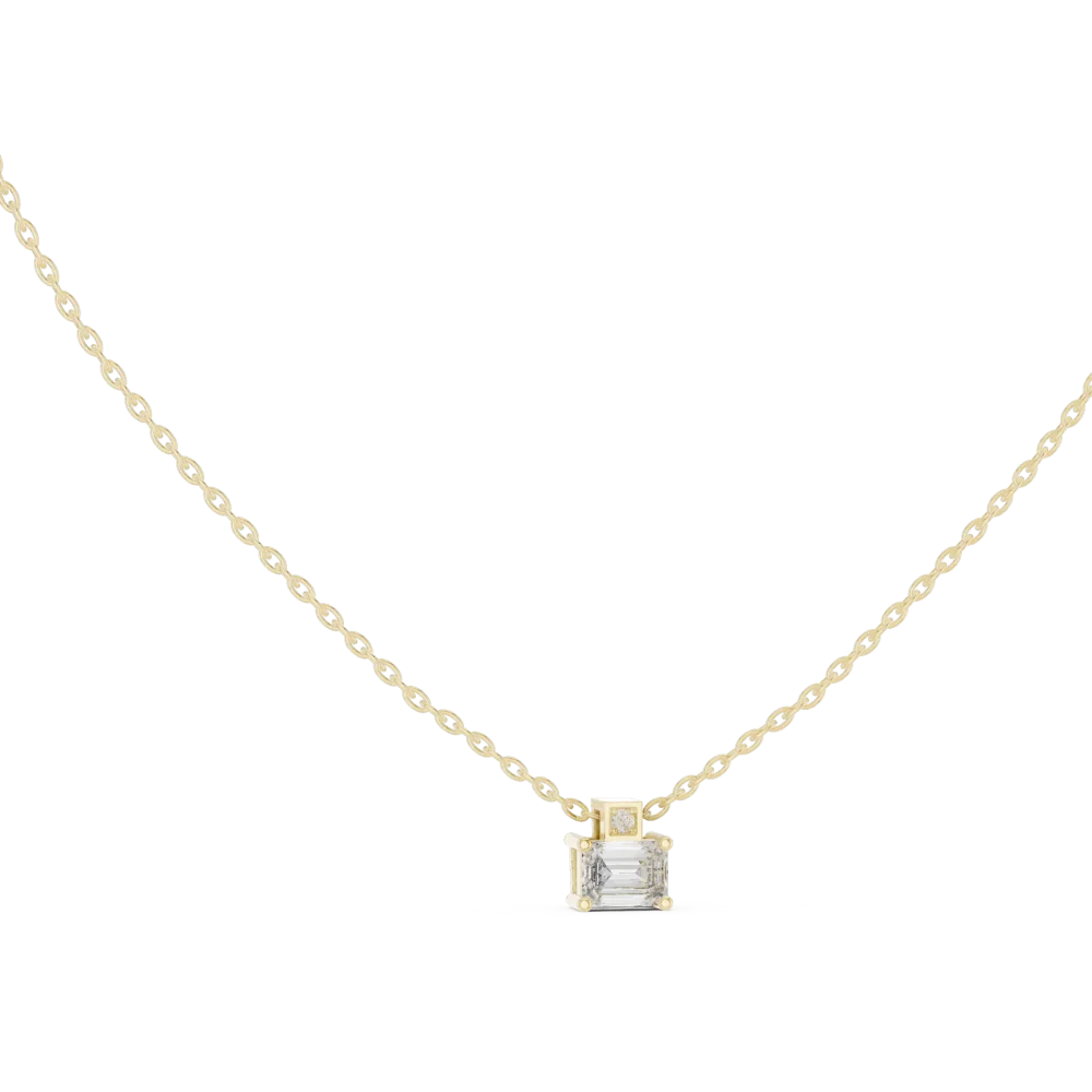Discover the geometric elegance of this Emerald and Round Solitaire Pendant. Featuring exquisite DIAMEUR diamonds, it's the ultimate modern luxury.