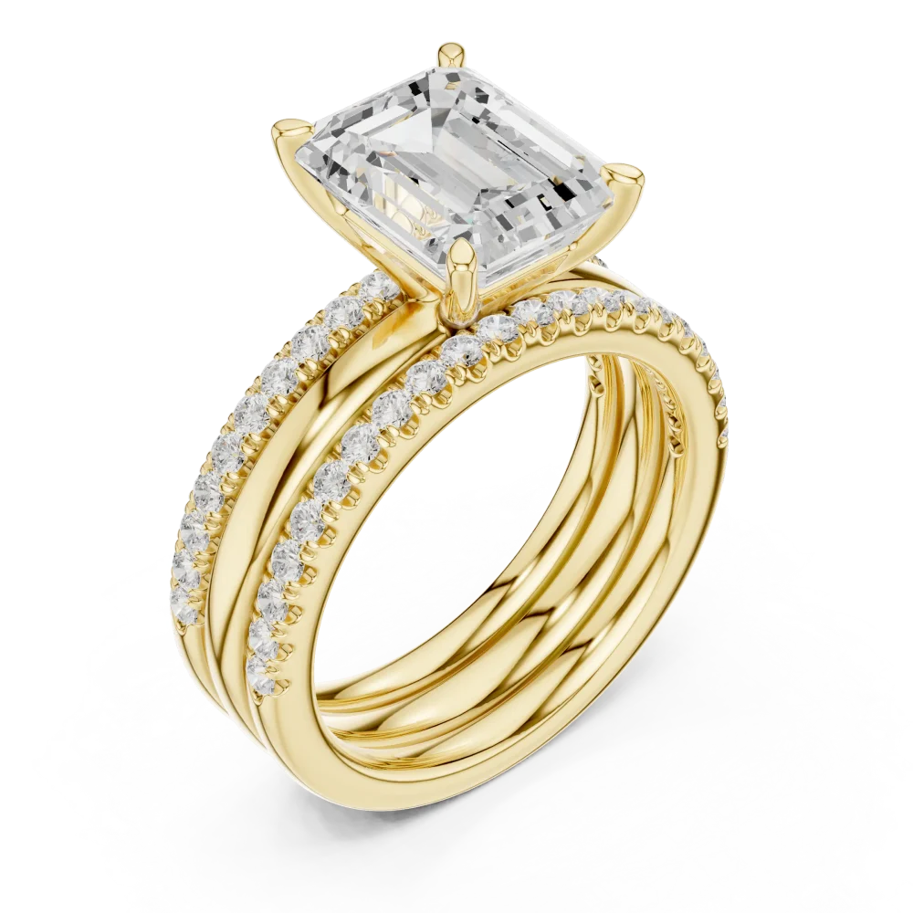 Experience the unmatched brilliance of an emerald-cut Solitaire centerpiece framed by delicate pavé. A true modern classic, shop this exquisite design.